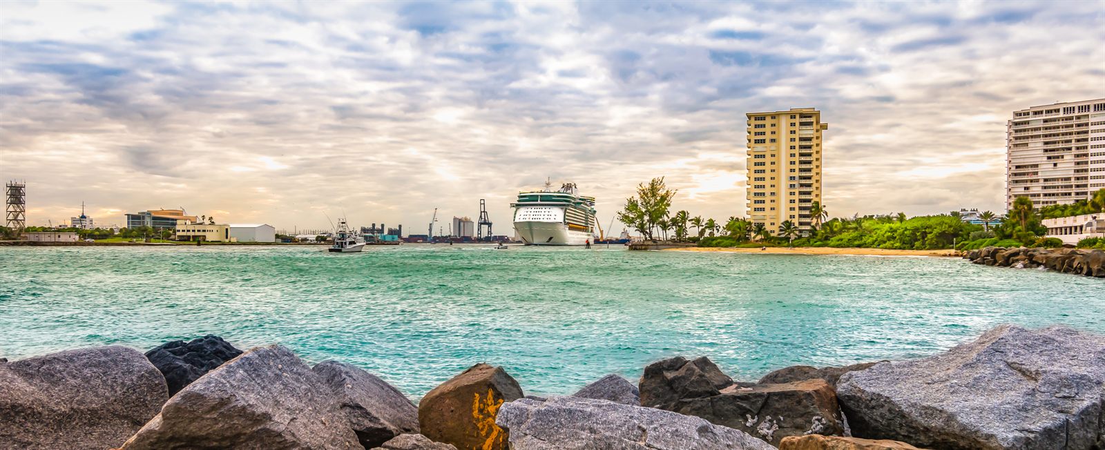 Turquoise water and rocks below a Florida coastal skyline